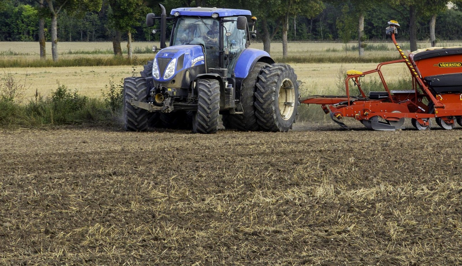 New Holland tractor seeding a field