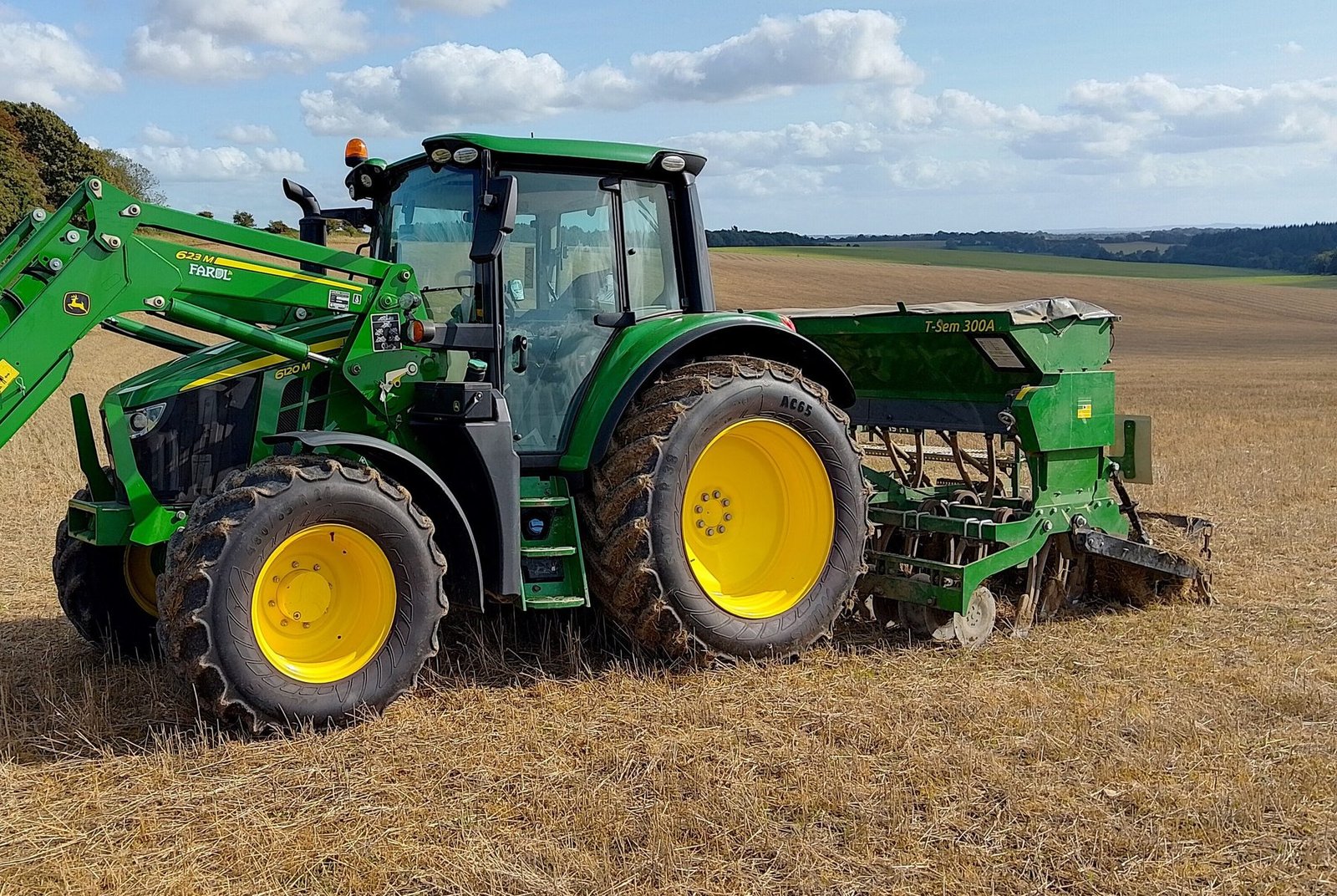 John Deere tractor with loader in a field